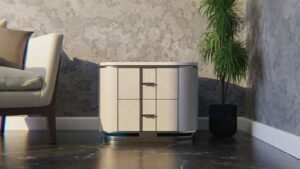 A modern nightstand next to a sofa and potted plant.