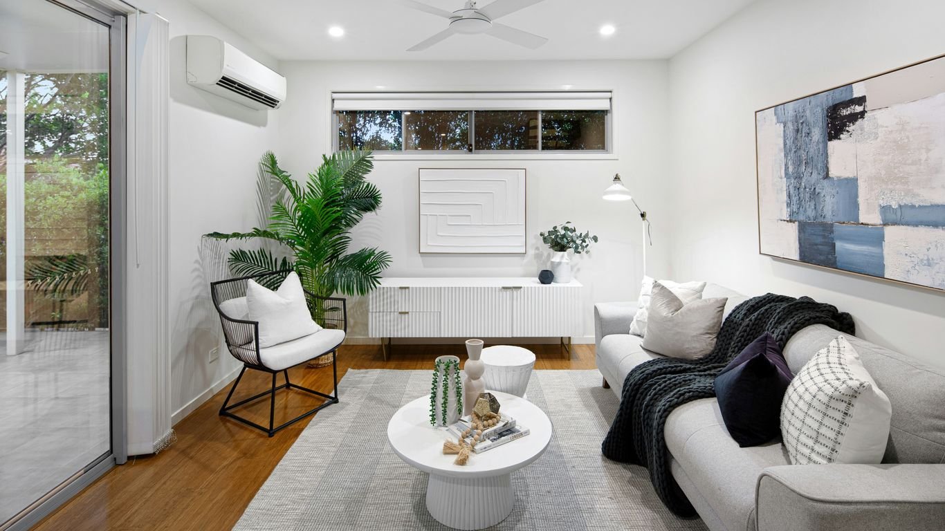 A living room filled with furniture and a ceiling fan